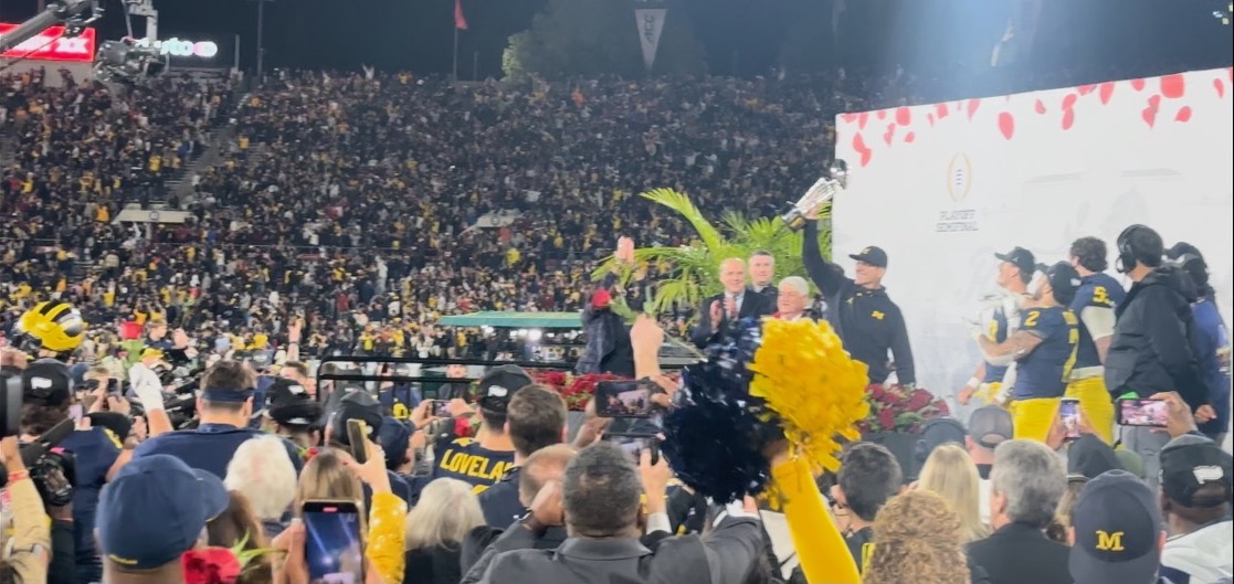 Head coach Jim Harbaugh of the Michigan Wolverines celebrates with The Leishman Trophy after beating the Alabama Crimson Tide 27-20 in overtime to win the CFP Semifinal Rose Bowl Game at Rose Bowl Stadium on January