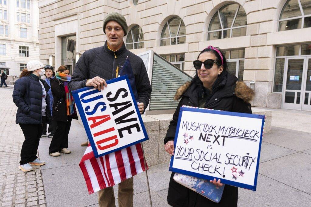 Protesters continued to gather outside the U.S. Agency for International Development on Monday, after Elon Musk and President Donald Trump made moves to dismantle the agency. (AP Video: Serkan Gurbuz)